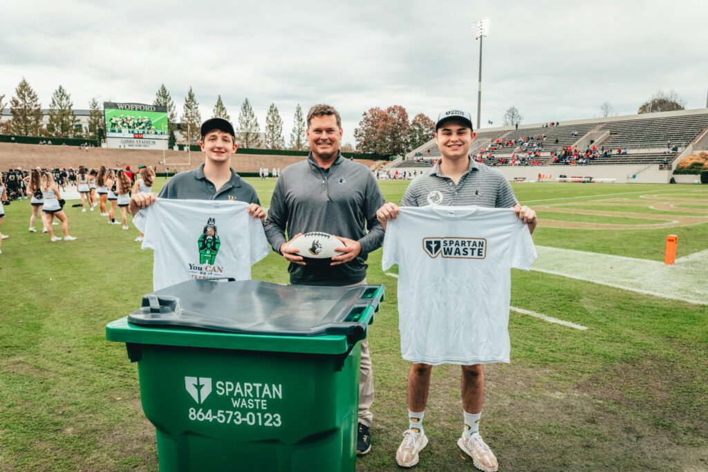 Mark Nelson with two Wofford students at football game.